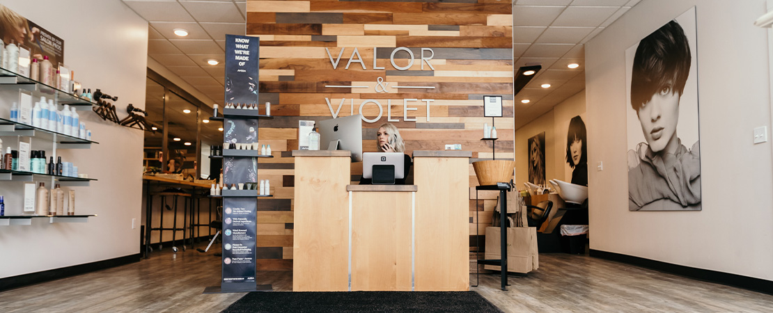 Receptionist on the phone at the Valor & Violet front desk