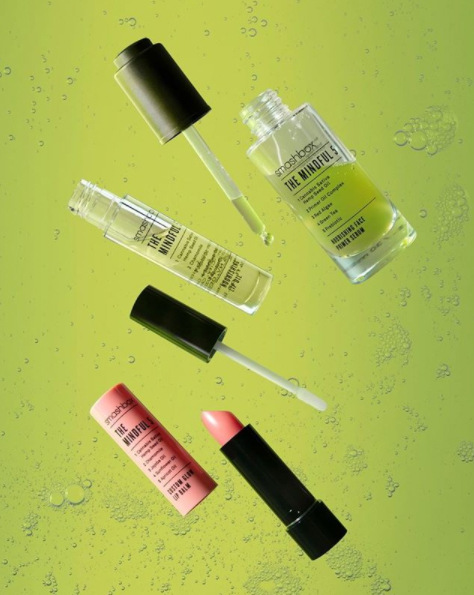 Assorted Smashbox products on a green background